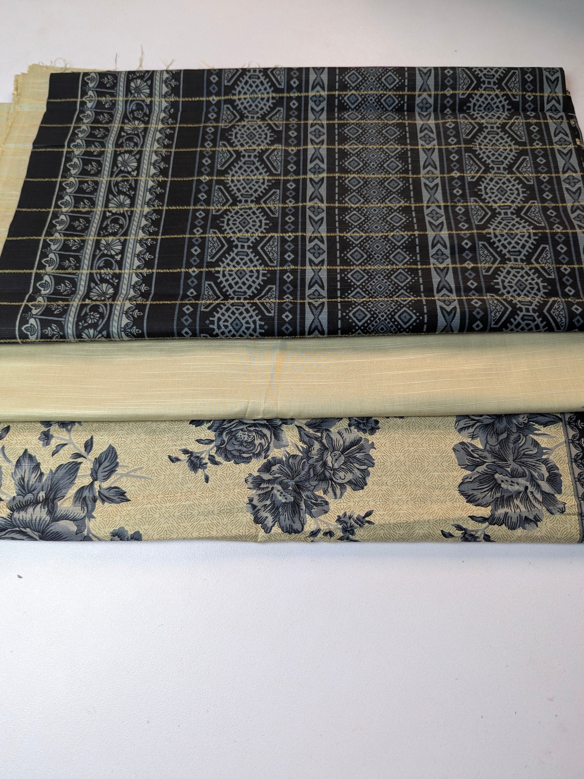 Two pieces of fabric with different patterns on a white background