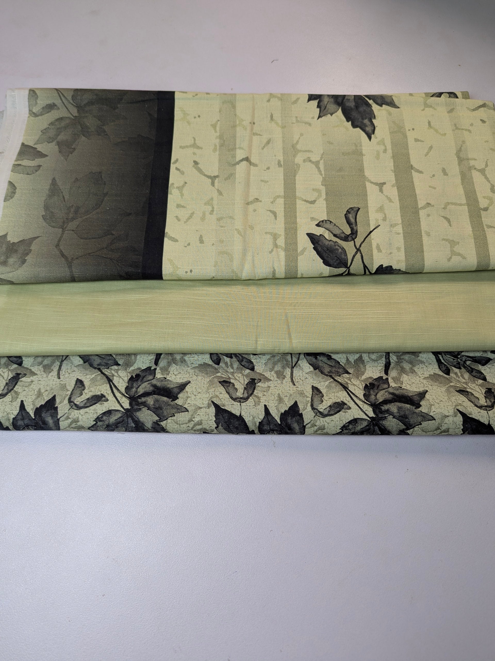 Roll of floral-patterned fabric on a white background