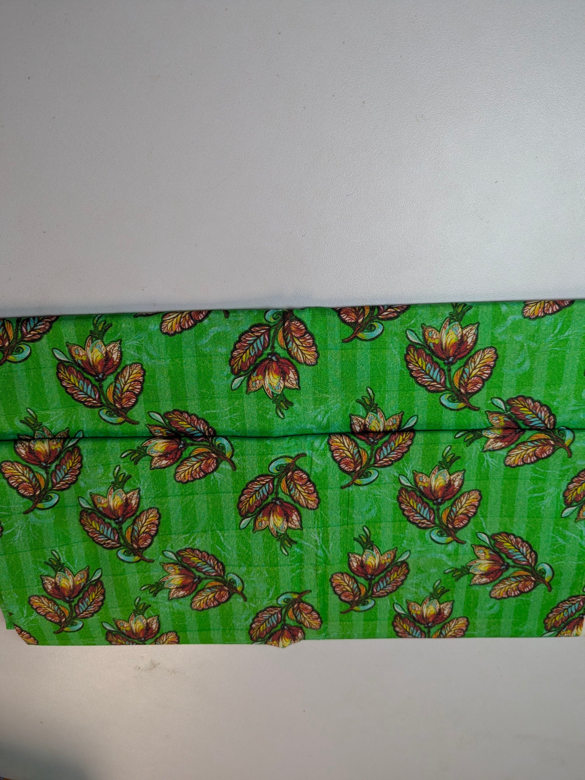 Green fabric with butterfly pattern on a white background