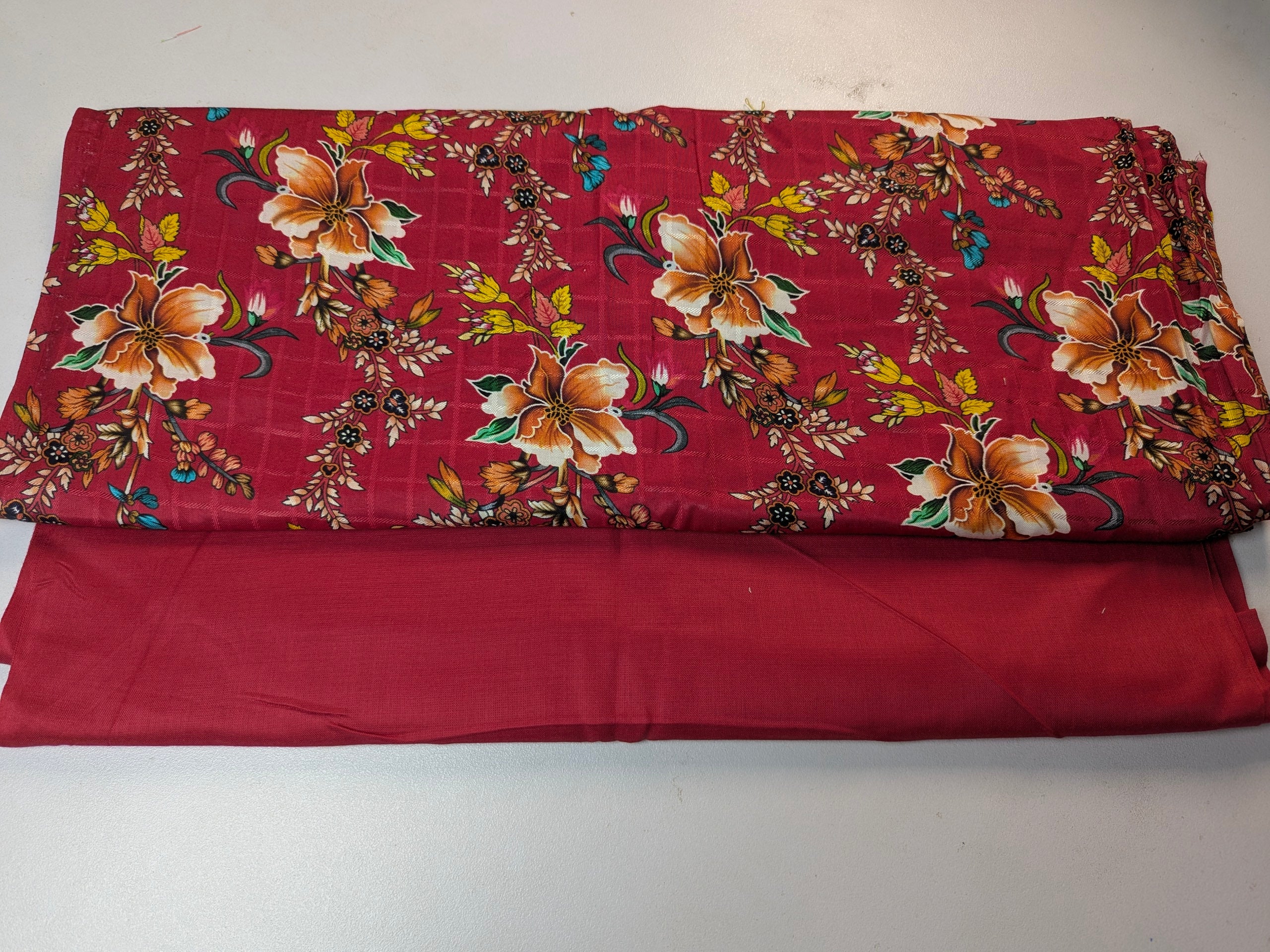 Red fabric with floral pattern on a white background
