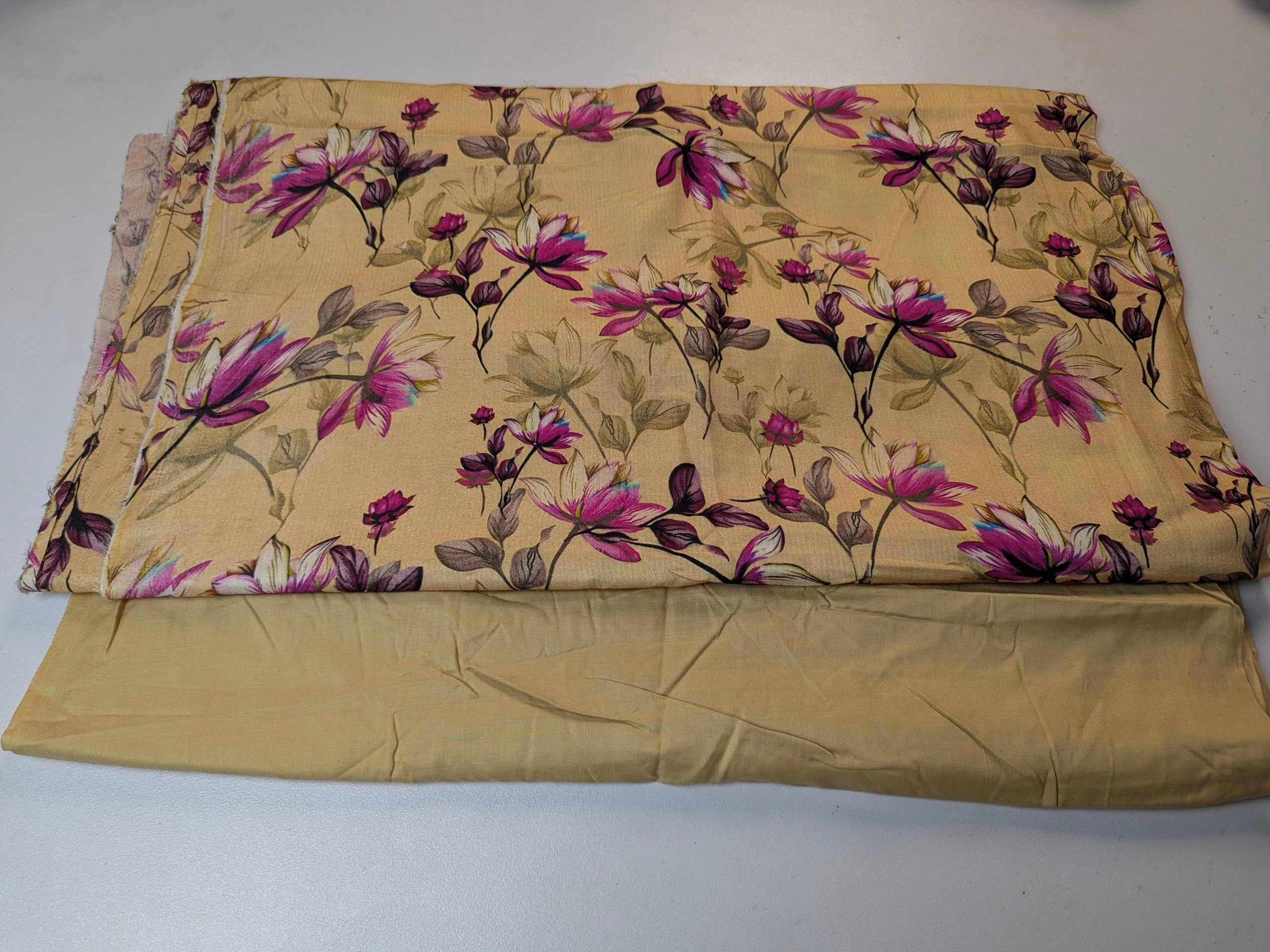 Folded fabric with floral pattern on a plain background