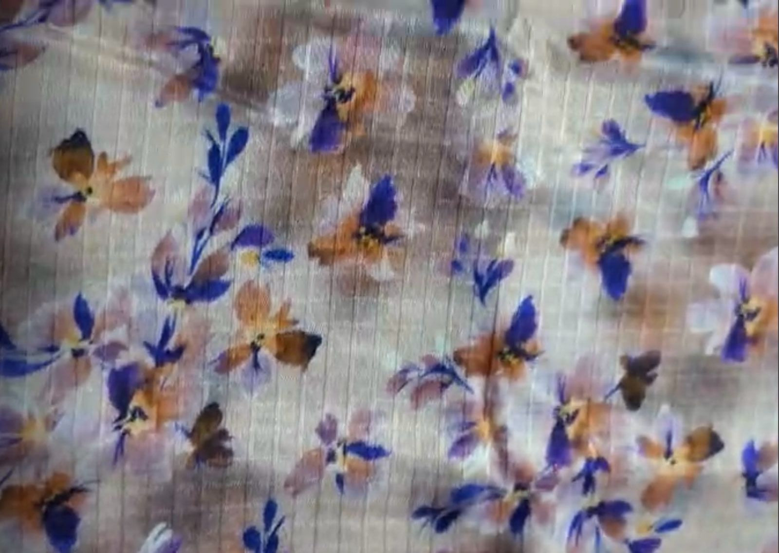 Floral patterned fabric with blue, orange, and purple flowers on a white background