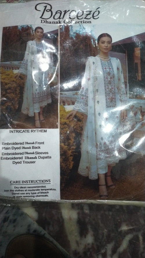 Packaged traditional outfit with intricate designs on a reflective surface